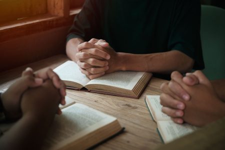 Christians are congregants join hands to pray and seek the blessings of God.